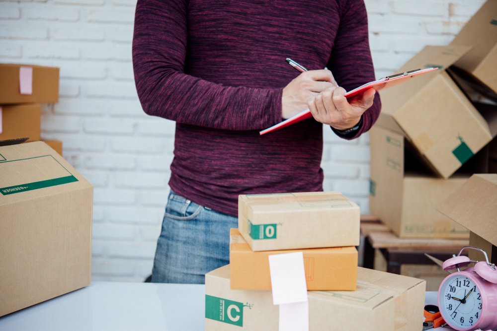 Picker packing an ecommerce order with branded materials